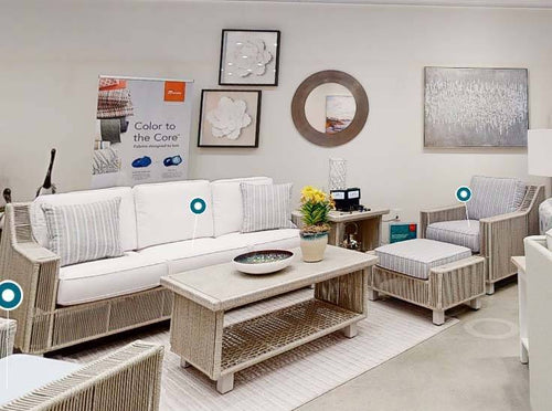 Luxe Outdoor Wicker Sofa with White Cushions and Striped Accent Pillows