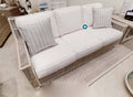 Luxe Outdoor Wicker Sofa with White Cushions and Striped Accent Pillows